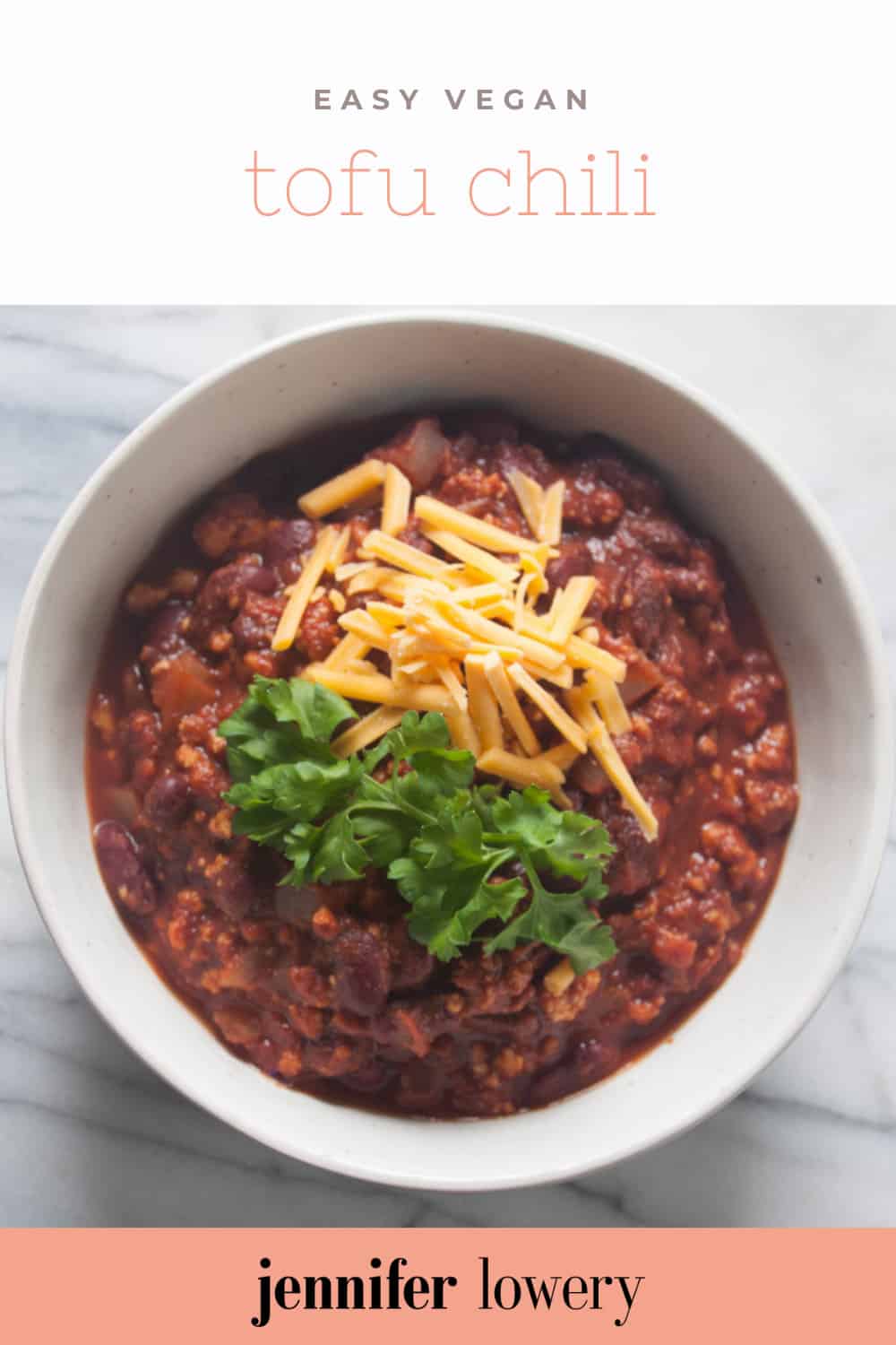 Easy Vegan Tofu Chili - A classic homemade dish made with spicy tofu crumbles topped with vegan cheese.