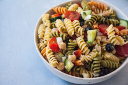 Bowl of Mediterranean Pasta Salad on grey background