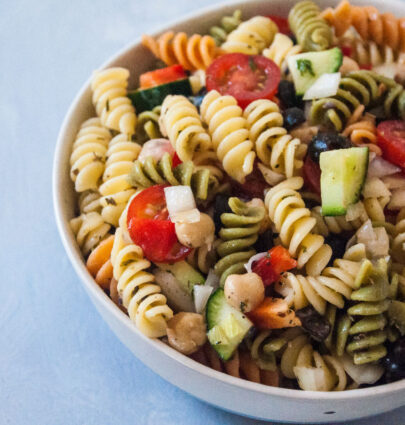 Bowl of Mediterranean Pasta Salad on grey background