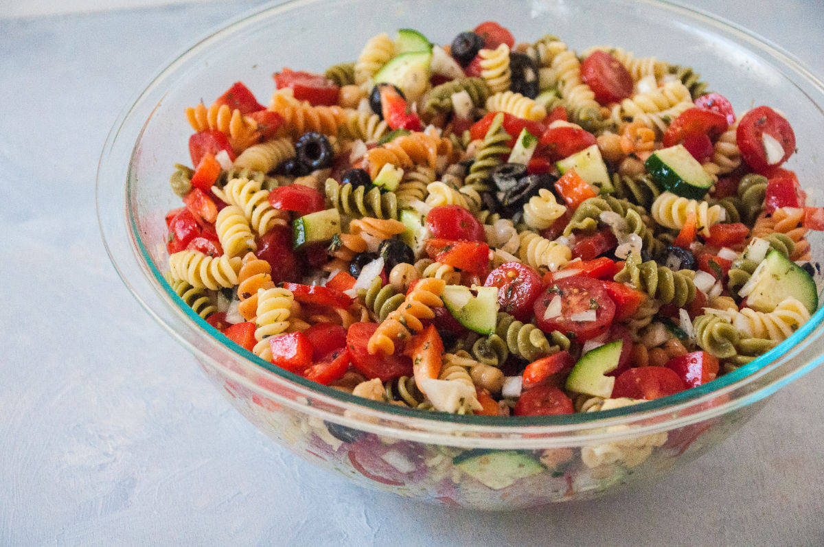 Bowl of Mediterranean Pasta Salad on grey background