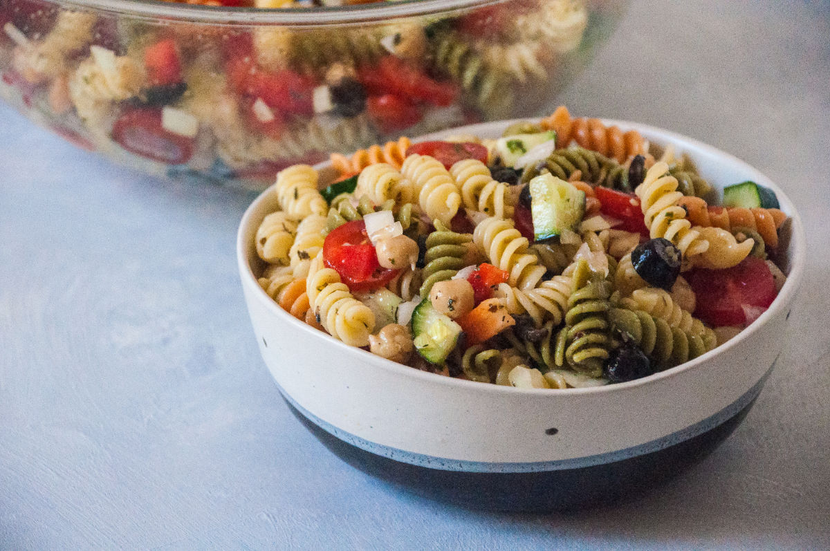 Two bowls of Mediterranean Pasta Salad on grey background