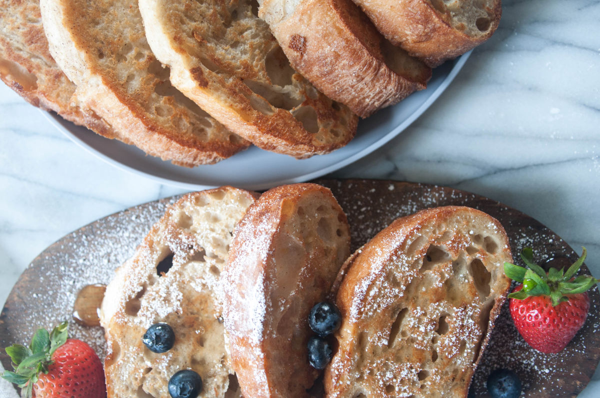 Vegan french toast slices on a wooden board with berries