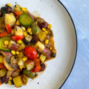 Cooked vegetable hash on a white plate